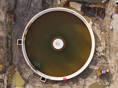 Diepenbeek Flanders Belgium 30 August 2026 Aerial view of a circular wastewater treatment tank at a construction site with muddy ground and heavy machinery. Diepenbeek Flanders Belgium 30 August 2026 Aerial view of a circular wastewater treatment tank at a construction site with muddy ground and heavy machinery.