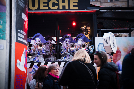 Basel Switzerland 10 March 2025 View of costumed musicians in pointed hats and masks blowing trumpets from a decorated stand at Fasnacht as onlookers gather in the street. Basel Switzerland 10 March 2025 View of costumed musicians in pointed hats and masks blowing trumpets from a decorated stand at Fasnacht as onlookers gather in the street.