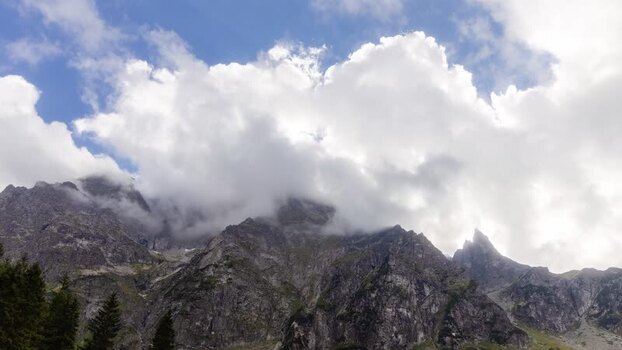 View of mountain peaks and clouds Rybie Oko Lake Poland. Timelapse.