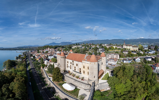 Aerial view of the historic Chateau de Grandson with its stone walls and red tiled roofs situated near the town and lake in Grandson Vaud Switzerland.