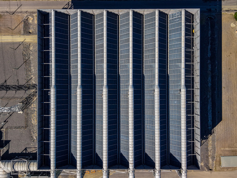 Aerial view of Millmerran Power Station featuring a large industrial building with a corrugated metal roof and structural support columns in Domville Queensland Australia. Aerial view of Millmerran Power Station featuring a large industrial building with a corrugated metal roof and structural support columns in Domville Queensland Australia.