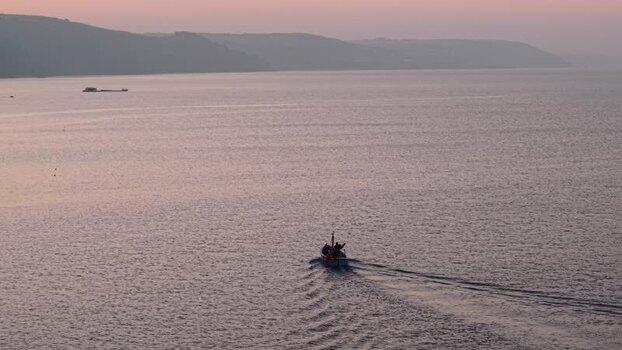 Aerial view of a fishing boat at sunset United Kingdom. Aerial view of a fishing boat at sunset United Kingdom.