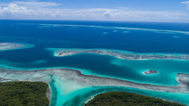 Aerial view of Los Roques archipelago featuring turquoise waters coral reefs and lush green islands in Los Roques Dependencias Federale Venezuela. Aerial view of Los Roques archipelago featuring turquoise waters coral reefs and lush green islands in Los Roques Dependencias Federale Venezuela.