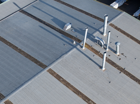 Melbourne VIC Australia 22 September 2026 Aerial view of an industrial factory roof in Kilsyth with ventilation pipes and exhaust vents casting long shadows in daylight. Melbourne VIC Australia 22 September 2026 Aerial view of an industrial factory roof in Kilsyth with ventilation pipes and exhaust vents casting long shadows in daylight.