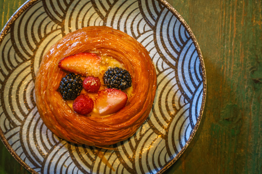 View of a danish pastry topped with strawberries blackberries and raspberries on a patterned plate at Ruba s Bakery Bistro in San Jose del Cabo Baja California Sur Mexico.