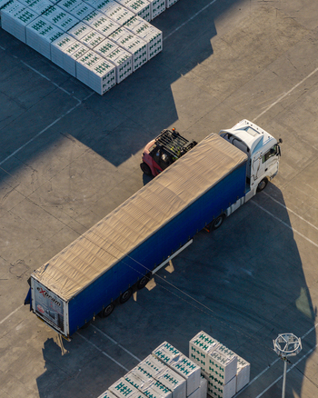 Warsaw Poland 14 September 2026 Aerial view of a truck parked at a construction site with stacks of H H building blocks and a forklift nearby captured in the warm light of the golden hour.