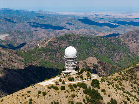 Aerial view of Kionia radar station situated on a mountain peak surrounded by pine forests and rugged terrain in Lazanias Lefkosia Cyprus. Aerial view of Kionia radar station situated on a mountain peak surrounded by pine forests and rugged terrain in Lazanias Lefkosia Cyprus.