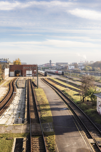 Berlin Germany 23 November 2022 View of railway tracks leading to a train depot with passenger trains parked on sidings under a soft morning sky. Berlin Germany 23 November 2022 View of railway tracks leading to a train depot with passenger trains parked on sidings under a soft morning sky.