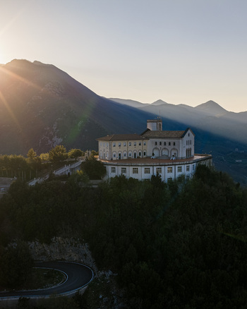 Aerial view of Santuario del Santissimo Salvatore perched on a lush hilltop overlooking the Picentini mountains during a golden sunset Montella Campania Italy. Aerial view of Santuario del Santissimo Salvatore perched on a lush hilltop overlooking the Picentini mountains during a golden sunset Montella Campania Italy.