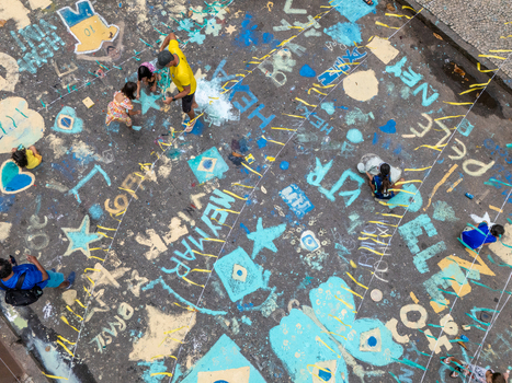 Rio de Janeiro Brazil 13 June 2026 Aerial view of people painting colorful football themed street art on the pavement with names like Neymar and Brazilian flags.