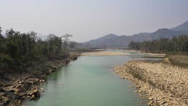 View of a wide river flowing through a valley Nepal.