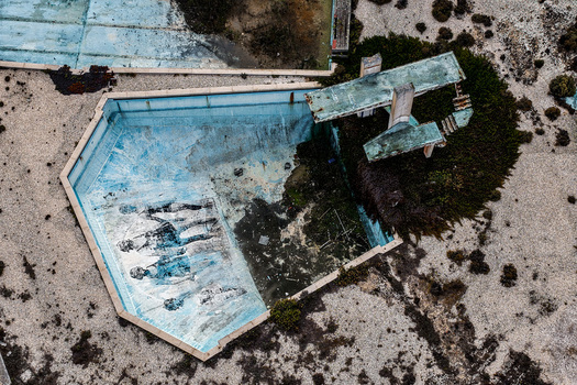 Aerial view of the abandoned swimming pool at Praia de Sao Pedro de Moel featuring a diving board and weathered murals in Marinha Grande Leiria Portugal. Aerial view of the abandoned swimming pool at Praia de Sao Pedro de Moel featuring a diving board and weathered murals in Marinha Grande Leiria Portugal.