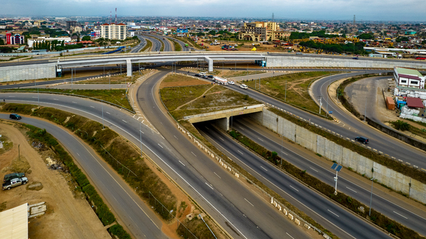 Aerial view of Tema Motorway interchange featuring multi level highway roads concrete overpasses and surrounding urban development in Accra Greater Accra Region Ghana. Aerial view of Tema Motorway interchange featuring multi level highway roads concrete overpasses and surrounding urban development in Accra Greater Accra Region Ghana.