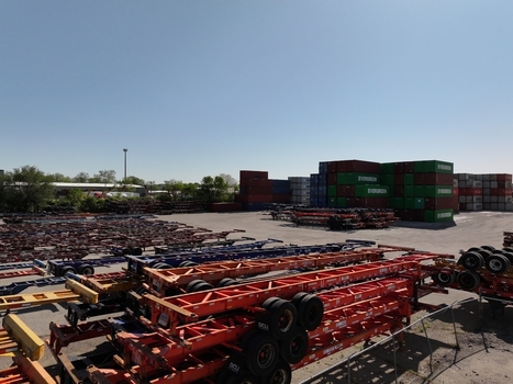 Cincinnati United States 19 April 2026 Aerial view of a shipping container yard with stacked Evergreen containers and rows of trailer chassis under a clear blue sky.