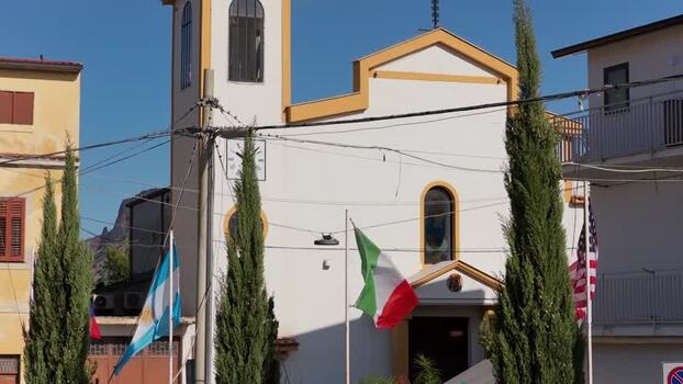 Aerial view of Borgo Parrini church and flags Italy.