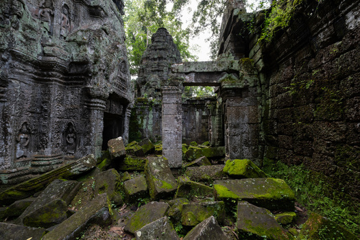 View of Angkor Wat temple ruins with moss covered stone blocks and intricate ancient carvings in Krong Siem Reap Siem Reap Province Cambodia. View of Angkor Wat temple ruins with moss covered stone blocks and intricate ancient carvings in Krong Siem Reap Siem Reap Province Cambodia.