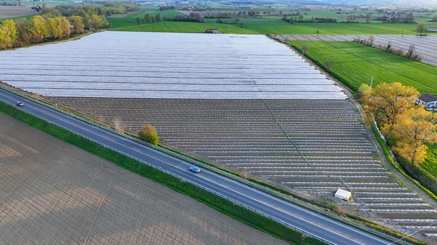 Aerial view of polytunnel fruit growing with white plastic covered rows protecting crops in the agricultural landscape of the Po Valley in Fiorenzuola d Arda Emilia Romagna Italy. Aerial view of polytunnel fruit growing with white plastic covered rows protecting crops in the agricultural landscape of the Po Valley in Fiorenzuola d Arda Emilia Romagna Italy.