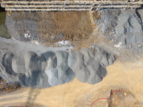 Aerial view of a construction site featuring large piles of gravel and sand on a dirt ground next to a concrete structure in Istanbul Istanbul Turkiye.