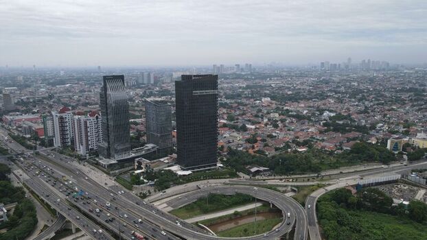 Aerial view of Jalan Tol Depok Antasari highway interchange with modern skyscrapers and dense urban sprawl in Kecamatan Cilandak Daerah Khusus Ibukota Indonesia. Aerial view of Jalan Tol Depok Antasari highway interchange with modern skyscrapers and dense urban sprawl in Kecamatan Cilandak Daerah Khusus Ibukota Indonesia.