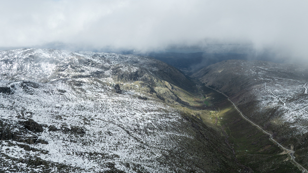 Aerial view of Glacial Valley of Zezere with snow dusted rocky slopes and low hanging clouds in Manteigas Guarda District Portugal. Aerial view of Glacial Valley of Zezere with snow dusted rocky slopes and low hanging clouds in Manteigas Guarda District Portugal.