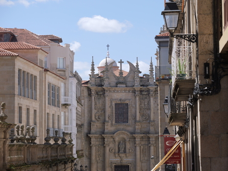 View of the ornate Baroque facade of Igrexa da Santa Eufemia in the historic city center with stone buildings and a clear blue sky in Ourense Ourense Spain.