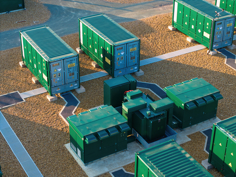 Aerial view of Battery Energy park BESS Grendon featuring rows of green battery storage containers and electrical infrastructure on a gravel site in Northampton England United Kingdom. Aerial view of Battery Energy park BESS Grendon featuring rows of green battery storage containers and electrical infrastructure on a gravel site in Northampton England United Kingdom.