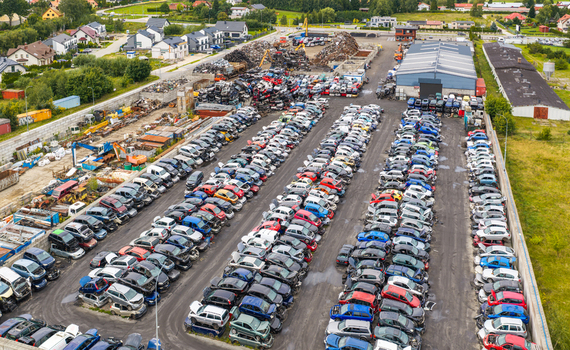 Aerial view of an end of life vehicle recycling facility with rows of salvaged cars scrap metal piles and industrial buildings in Gdansk Pomeranian Voivodeship Poland. Aerial view of an end of life vehicle recycling facility with rows of salvaged cars scrap metal piles and industrial buildings in Gdansk Pomeranian Voivodeship Poland.