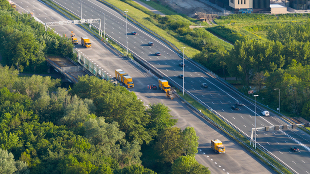 Waardenburg Netherlands 09 May 2026 Aerial view of road maintenance vehicles parked on the shoulder of a busy multi lane highway surrounded by dense green trees. Waardenburg Netherlands 09 May 2026 Aerial view of road maintenance vehicles parked on the shoulder of a busy multi lane highway surrounded by dense green trees.