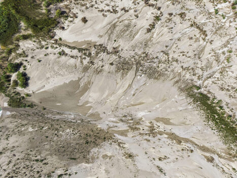 Aerial view of the sandy riverbanks and natural erosion patterns within Vjosa Wild River National Park Permet Gjirokaster County Albania. Aerial view of the sandy riverbanks and natural erosion patterns within Vjosa Wild River National Park Permet Gjirokaster County Albania.