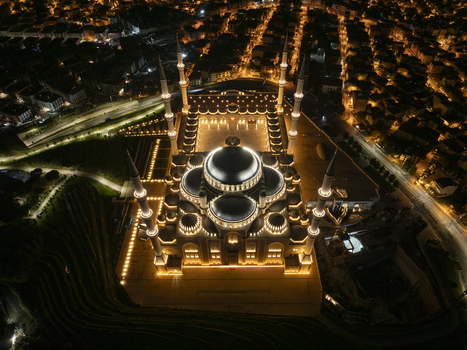 Aerial view of the Grand Camlica Mosque illuminated at night featuring grand domes and tall minarets Uskudar Istanbul Turkiye. Aerial view of the Grand Camlica Mosque illuminated at night featuring grand domes and tall minarets Uskudar Istanbul Turkiye.