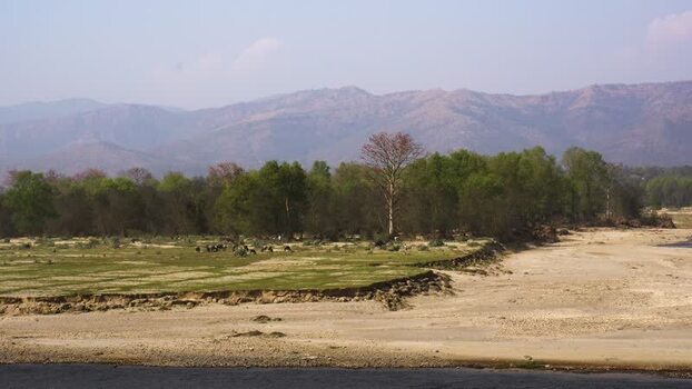 View of a dry riverbed and distant mountains Nepal.