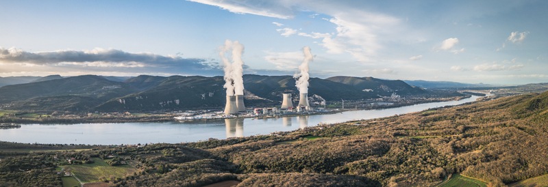 Cruas France 12 February 2026 Aerial view of the Cruas Nuclear Center with its cooling towers emitting steam situated along the Rhone river amidst rolling hills and forests. Cruas France 12 February 2026 Aerial view of the Cruas Nuclear Center with its cooling towers emitting steam situated along the Rhone river amidst rolling hills and forests.