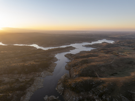 Aerial view of the winding river and reservoir at sunset with golden light illuminating the dry landscape in Kirklareli Merkez Kirklareli Turkiye. Aerial view of the winding river and reservoir at sunset with golden light illuminating the dry landscape in Kirklareli Merkez Kirklareli Turkiye.