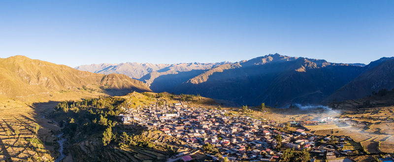Aerial view of Cabanaconde village nestled in the Andes mountains with terraced fields rugged slopes and golden sunlight in Cabanaconde Arequipa Peru. Aerial view of Cabanaconde village nestled in the Andes mountains with terraced fields rugged slopes and golden sunlight in Cabanaconde Arequipa Peru.