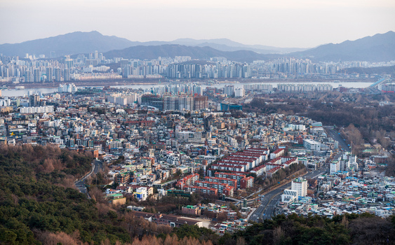 Aerial view of the dense urban landscape featuring residential buildings high rise apartments and the Han River under a clear sky in Seoul South Korea. Aerial view of the dense urban landscape featuring residential buildings high rise apartments and the Han River under a clear sky in Seoul South Korea.