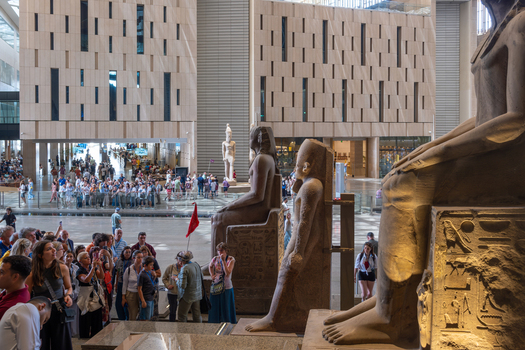 Giza Egypt 16 May 2026 View of the Grand Egyptian Museum interior featuring massive ancient Egyptian statues and crowds of tourists exploring the modern hall.