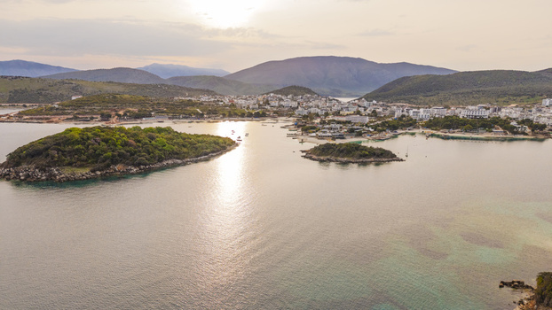Aerial view of the coastal town of Ksamil with its islands turquoise waters and buildings under the soft light of sunset in Ksamil Vlore County Albania. Aerial view of the coastal town of Ksamil with its islands turquoise waters and buildings under the soft light of sunset in Ksamil Vlore County Albania.