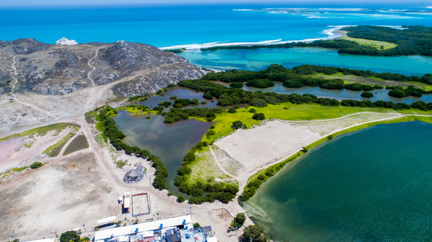 Aerial view of Los Roques archipelago featuring turquoise waters vibrant mangroves sandy coastal areas and rocky hills in Los Roques Dependencias Federales Venezuela. Aerial view of Los Roques archipelago featuring turquoise waters vibrant mangroves sandy coastal areas and rocky hills in Los Roques Dependencias Federales Venezuela.