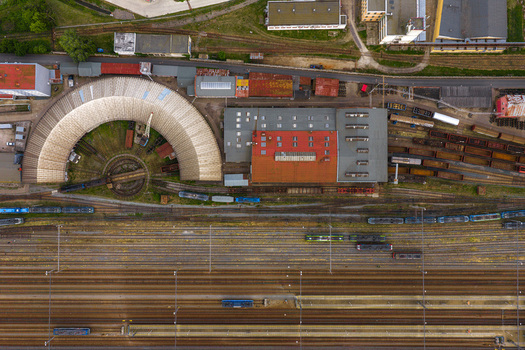 Aerial view of the railway depot featuring a historic roundhouse and turntable with trains on multiple tracks in Breclav South Moravian Region Czechia.