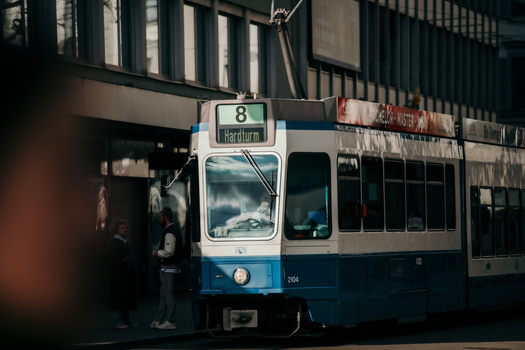 Zurich Switzerland 02 April 2023 View of a blue and white tram at the Hardturm stop reflects the city s sleek modernity against the backdrop of the National Museum Zurich. Zurich Switzerland 02 April 2023 View of a blue and white tram at the Hardturm stop reflects the city s sleek modernity against the backdrop of the National Museum Zurich.