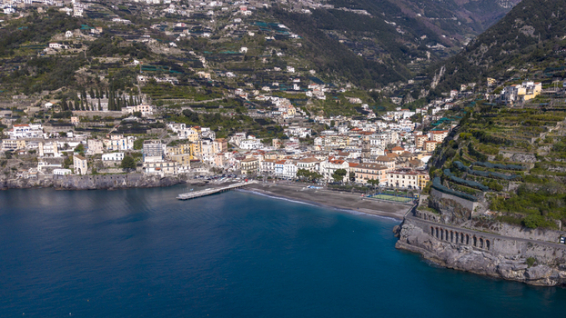 Aerial view of the coastal town clinging to steep slopes where buildings meet the sea in a symphony of color and form Minori Salerno Italy Aerial view of the coastal town clinging to steep slopes where buildings meet the sea in a symphony of color and form Minori Salerno Italy
