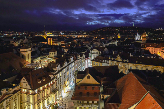 Aerial view of historic city center with illuminated rooftops narrow streets and glowing windows under a twilight sky in Prague Prague Czechia. Aerial view of historic city center with illuminated rooftops narrow streets and glowing windows under a twilight sky in Prague Prague Czechia.