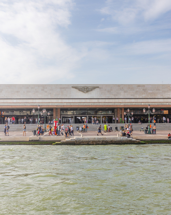 Venice Italy 21 September 2026 View of the Venice Santa Lucia railway station with people walking along the waterfront promenade on a sunny day. Venice Italy 21 September 2026 View of the Venice Santa Lucia railway station with people walking along the waterfront promenade on a sunny day.