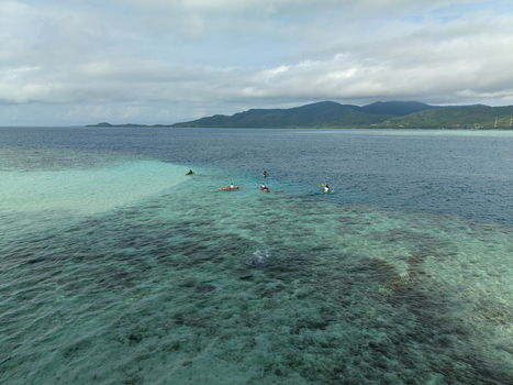 Aerial view of azure waters meet the horizon near Menjangan Kecil Island a tropical haven under a cloudy sky Karimunjawa Central Java Indonesia.