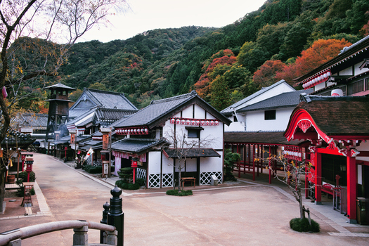 Nikko Tochigi Japan 02 November 2025 View of Edo Wonderland Nikko Edomura with traditional wooden buildings tiled roofs red accents and autumn foliage on the hills. Nikko Tochigi Japan 02 November 2025 View of Edo Wonderland Nikko Edomura with traditional wooden buildings tiled roofs red accents and autumn foliage on the hills.