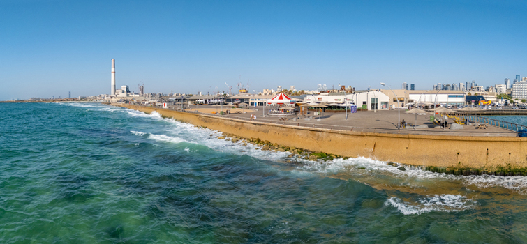 Aerial view of the Tel Aviv Port promenade with the Mediterranean Sea a carousel and the Reading Power Station chimney in Tel Aviv Yafo Tel Aviv District Israel. Aerial view of the Tel Aviv Port promenade with the Mediterranean Sea a carousel and the Reading Power Station chimney in Tel Aviv Yafo Tel Aviv District Israel.