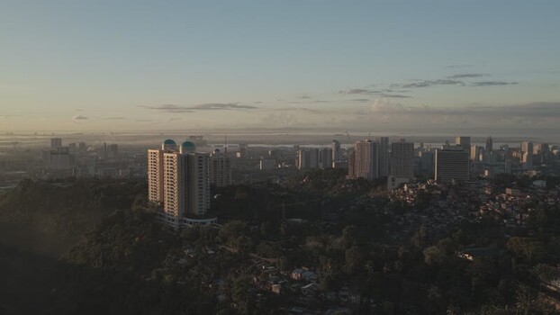 Aerial view of the Cebu City skyline and lush hills Philippines.