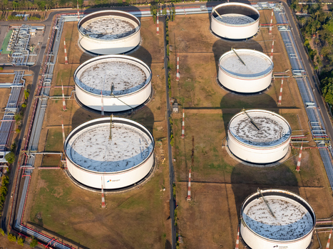 Aerial view of large white oil storage tanks at the Pertamina refinery facility in Cilacap Central Java Indonesia. Aerial view of large white oil storage tanks at the Pertamina refinery facility in Cilacap Central Java Indonesia.
