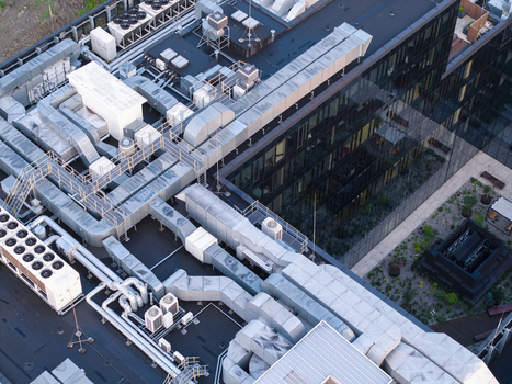 Aerial view of the rooftop of a data center featuring extensive HVAC ventilation systems cooling units and metal ductwork in Krakow Lesser Poland Voivode Poland. Aerial view of the rooftop of a data center featuring extensive HVAC ventilation systems cooling units and metal ductwork in Krakow Lesser Poland Voivode Poland.