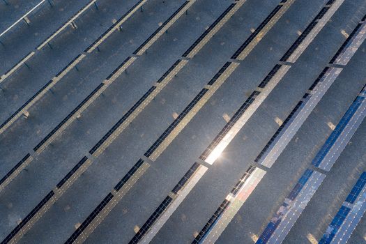 Aerial view of rows of solar panels reflecting bright sunlight in a large renewable energy farm in Enterprise Nevada United States. Aerial view of rows of solar panels reflecting bright sunlight in a large renewable energy farm in Enterprise Nevada United States.